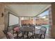 Outdoor covered patio with dining set and roll down movie screen overlooking the pool at 3717 Moonshine Falls Ave, North Las Vegas, NV 89085