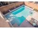 View looking down at a pristine backyard pool with steps leading into the water at 3717 Moonshine Falls Ave, North Las Vegas, NV 89085