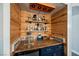Close up of the bar area features open shelving, under-counter fridge, and custom wood accents at 3717 Moonshine Falls Ave, North Las Vegas, NV 89085