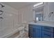 Bathroom with modern vanity, large mirror, and white tiled shower at 384 E Erin St # 3, Pahrump, NV 89048