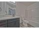 Bathroom featuring modern vanity, large mirror, and tiled tub at 384 E Erin St # 3, Pahrump, NV 89048