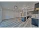 Bright and airy living room featuring a modern kitchen and wood-look flooring at 384 E Erin St # 3, Pahrump, NV 89048