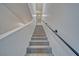 Carpeted staircase with black metal handrail in a modern home at 384 E Erin St # 3, Pahrump, NV 89048