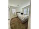 This bedroom features neutral-colored walls, carpet, a ceiling fan, and a comfortable bed at 384 Gracious Way, Henderson, NV 89011