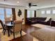 Open-concept living room featuring hardwood floors, a ceiling fan, and a dining room at 384 Gracious Way, Henderson, NV 89011