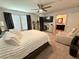 This main bedroom features a ceiling fan, TV, mirrored dresser, and an entrance to the main bathroom at 384 Gracious Way, Henderson, NV 89011