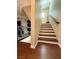 Stylish staircase featuring dark wood steps and white risers, connecting the home's floors at 384 Gracious Way, Henderson, NV 89011