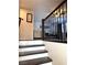 Elegant staircase with dark wood steps and white risers leading to the upper level living spaces at 384 Gracious Way, Henderson, NV 89011