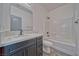 Contemporary bathroom features a sleek vanity with a gray cabinet and a shower-tub combo at 388 E Erin St # 4, Pahrump, NV 89048