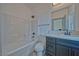 Bathroom featuring modern vanity, tile flooring, and shower-tub combo with white tile surround at 388 E Erin St # 4, Pahrump, NV 89048