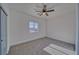 Minimalist bedroom with neutral carpet, a ceiling fan, and a window view at 388 E Erin St # 4, Pahrump, NV 89048