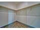 Walk-in closet featuring neutral carpet, white walls and shelving with wood closet rod for storage at 388 E Erin St # 4, Pahrump, NV 89048