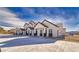 Exterior view of newly constructed townhomes with white stucco, dark trim, and ample parking at 388 E Erin St # 4, Pahrump, NV 89048