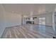 Inviting living room flows to the kitchen featuring gray cabinets and abundant natural light at 388 E Erin St # 4, Pahrump, NV 89048