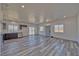 Open-concept layout with gray vinyl plank flooring, lots of natural light, and sleek kitchen at 388 E Erin St # 4, Pahrump, NV 89048