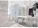 Luxurious bathroom showcasing a glass-enclosed shower, marble finishes, and modern fixtures for a spa-like experience at 4381 W Flamingo Rd # 2504, Las Vegas, NV 89103