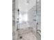 Modern marble bathroom with a sleek shower, bathtub, and contemporary fixtures, creating a spa-like experience at 4381 W Flamingo Rd # 2504, Las Vegas, NV 89103