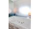 Relaxing soaking tub with jets, set against a mirrored wall, offering a serene spa-like experience at 4381 W Flamingo Rd # 2504, Las Vegas, NV 89103