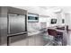 Modern kitchenette featuring stainless steel appliances, sink, and barstool seating at 4381 W Flamingo Rd # 2504, Las Vegas, NV 89103