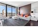 Modern living room with city views, featuring a comfortable couch, and a glass table for a cozy and sophisticated living at 4381 W Flamingo Rd # 2504, Las Vegas, NV 89103