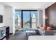 Bright living room featuring a modern sofa, expansive windows with a city view, and sleek furnishings at 4381 W Flamingo Rd # 2504, Las Vegas, NV 89103