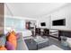 Modern living room featuring sleek furniture, hardwood floors, and a flat-screen TV, all illuminated with bright, natural light at 4381 W Flamingo Rd # 2504, Las Vegas, NV 89103