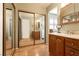 Bathroom with dual sinks, vanity, large mirrors and wood-look flooring at 4726 Idaho Ave, Las Vegas, NV 89104