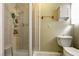 Tiled shower with glass door in bathroom with a toilet and cabinet on the wall at 4726 Idaho Ave, Las Vegas, NV 89104