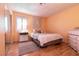 Bedroom with peach-colored walls, plantation shutters and a double bed at 4726 Idaho Ave, Las Vegas, NV 89104