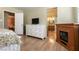Bedroom featuring a dresser, fireplace, and a mirrored closet, all with wood flooring at 4726 Idaho Ave, Las Vegas, NV 89104