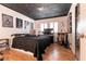 Bedroom with black and white decor, wooden floors, and shuttered windows at 4726 Idaho Ave, Las Vegas, NV 89104