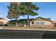 Charming single-story home featuring brick accents, wood siding and mature trees, showcasing curb appeal at 4726 Idaho Ave, Las Vegas, NV 89104