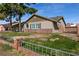 View of the side of the home, showcasing the brick accents and a well-maintained lawn at 4726 Idaho Ave, Las Vegas, NV 89104