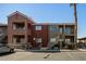 Exterior view of apartments featuring neutral paint and two-story buildings with stairway and parking at 4730 E Craig Rd # 2190, Las Vegas, NV 89115