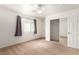 Bright bedroom features a ceiling fan, window with curtains, and a closet with mirrored doors at 4730 E Craig Rd # 2190, Las Vegas, NV 89115