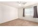 This bedroom features a neutral carpet and a large bright window for natural light at 4730 E Craig Rd # 2190, Las Vegas, NV 89115