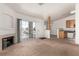 Open-concept living space with fireplace, sliding door, and view to kitchen offers comfortable living at 4730 E Craig Rd # 2190, Las Vegas, NV 89115