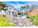 Expansive backyard with a swimming pool, outdoor kitchen, and landscaped areas at 511 Beaconwood St, Henderson, NV 89052
