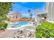 Lush backyard featuring a rock-lined pool, spa, and an outdoor kitchen at 511 Beaconwood St, Henderson, NV 89052