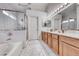 Bright bathroom featuring a separate shower, tub, and a dual sink vanity at 511 Beaconwood St, Henderson, NV 89052