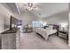 Bright bedroom with neutral carpet, a ceiling fan and ample closet space at 511 Beaconwood St, Henderson, NV 89052
