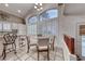 Charming dining area with vaulted ceiling, large window, and a table with four chairs at 511 Beaconwood St, Henderson, NV 89052