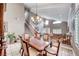 Formal dining room with a large wooden table and chairs and access to the living room at 511 Beaconwood St, Henderson, NV 89052