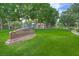 Scenic view of Friendship Park featuring lush green lawns, mature trees, and a playground in a peaceful setting at 511 Beaconwood St, Henderson, NV 89052