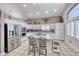 Well-lit kitchen boasting granite countertops, stainless steel appliances, and an island with bar stool seating at 511 Beaconwood St, Henderson, NV 89052