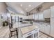 Spacious kitchen with granite countertops, stainless steel appliances, an island, and a tile backsplash at 511 Beaconwood St, Henderson, NV 89052