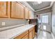 Well-lit laundry room with cabinets, sink, tile countertop, washer, and dryer at 511 Beaconwood St, Henderson, NV 89052