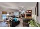 Cozy living room with dark leather furniture, a ceiling fan, and a fireplace at 511 Beaconwood St, Henderson, NV 89052