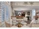 Open dining and living area featuring wooden floors, shutters on the windows, and a glass table at 511 Beaconwood St, Henderson, NV 89052