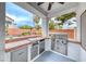 Covered outdoor kitchen with a built-in stainless steel grill and lush desert landscaping at 511 Beaconwood St, Henderson, NV 89052